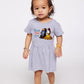Child wearing a gray dress with 'Beauty and the Beast' print on a white background